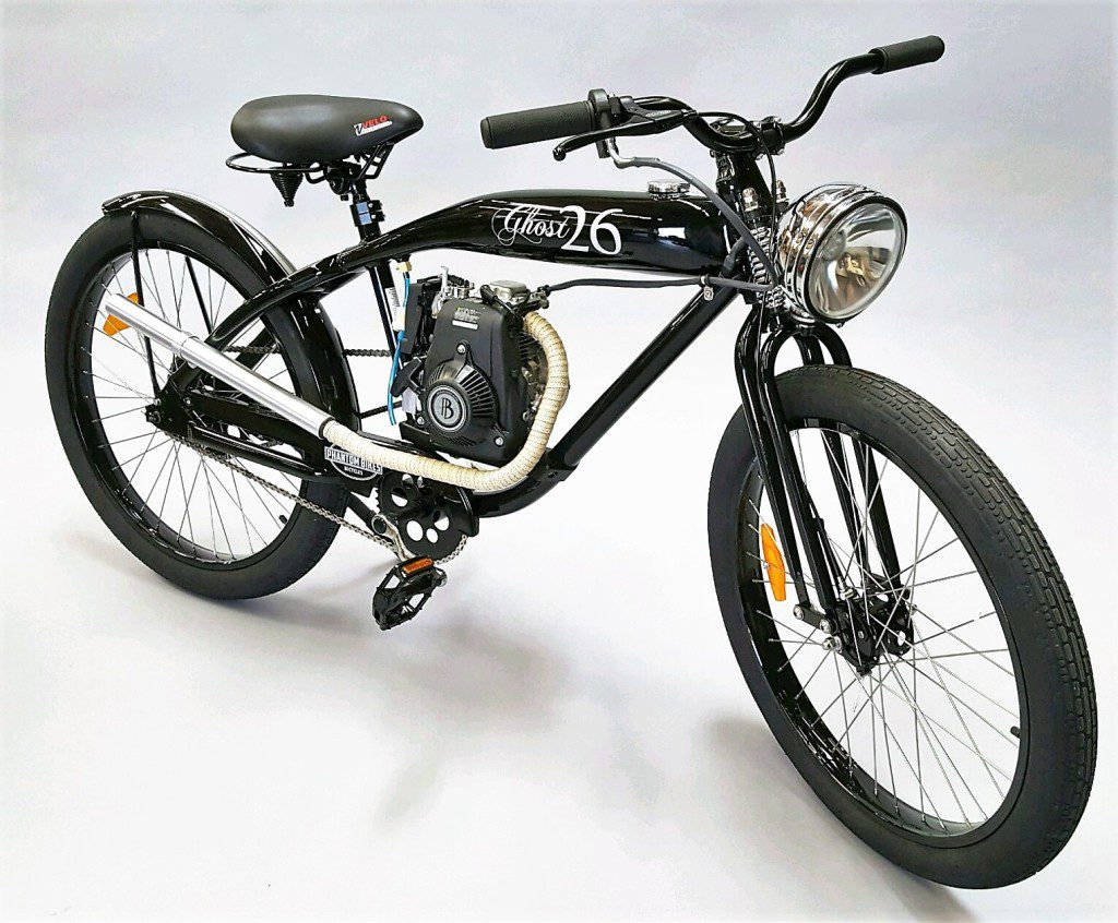 A black bike with a small engine sitting on a white background.