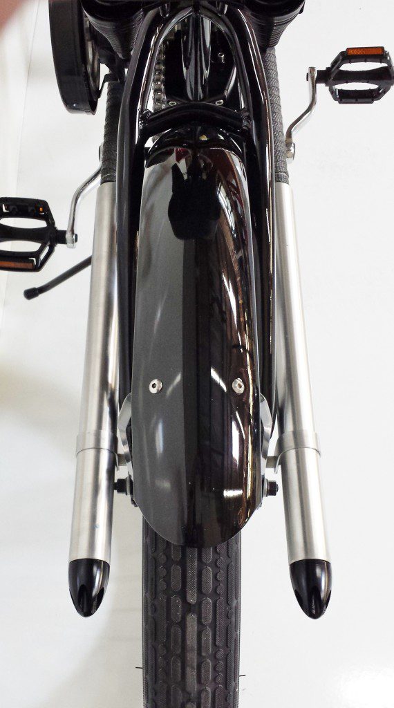 A close up of a black motorcycle with a chrome exhaust.