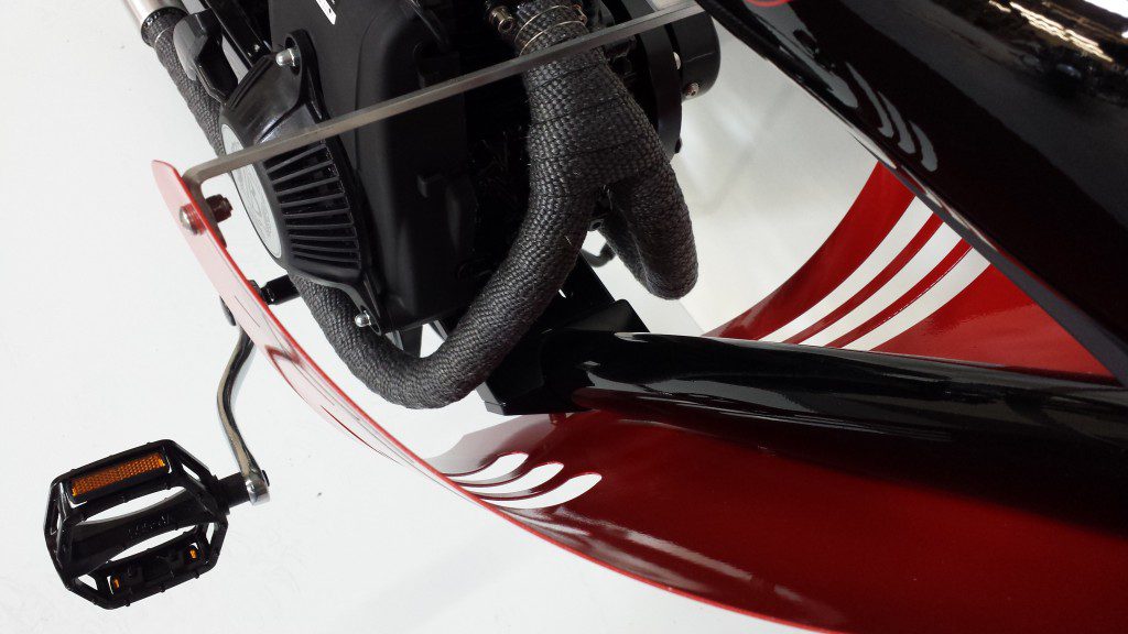 A close up of a red motorcycle with a black handlebar.