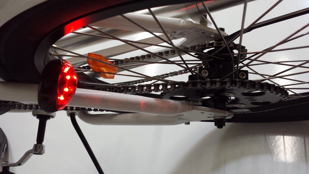 A bicycle with a red light attached to it.