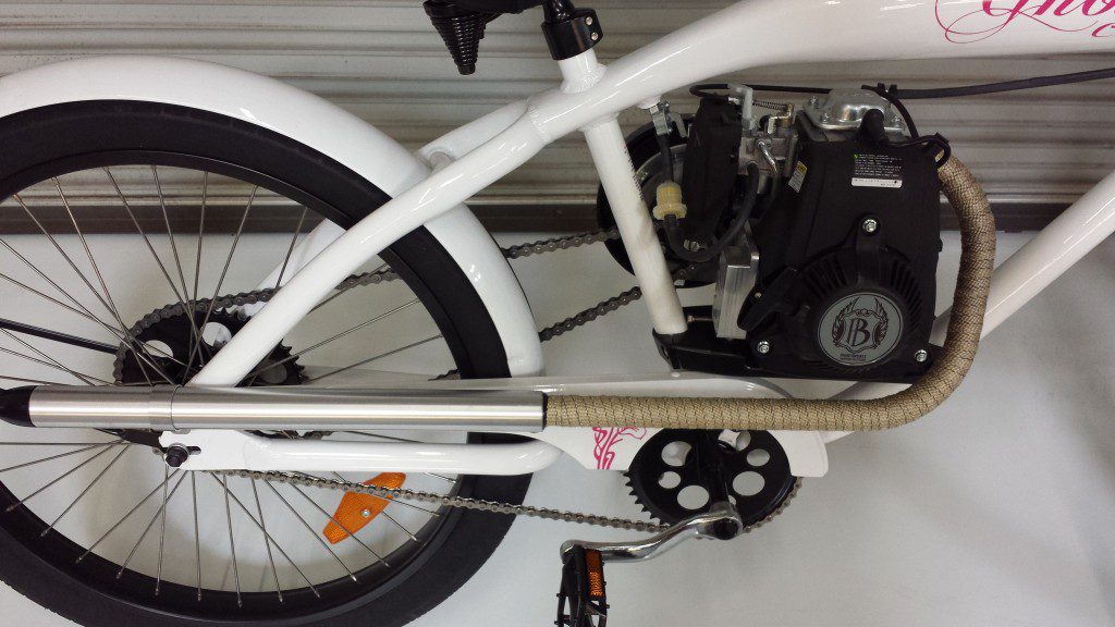 A white bike with a motor attached to it.