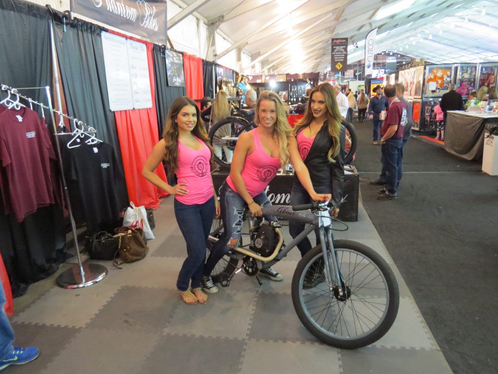 Three women and a bike in an exhibition