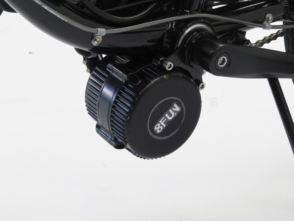 A close up of a bicycle with a motor attached to it.