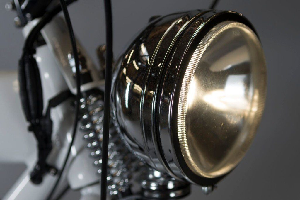 A close up of the headlight on a bicycle.