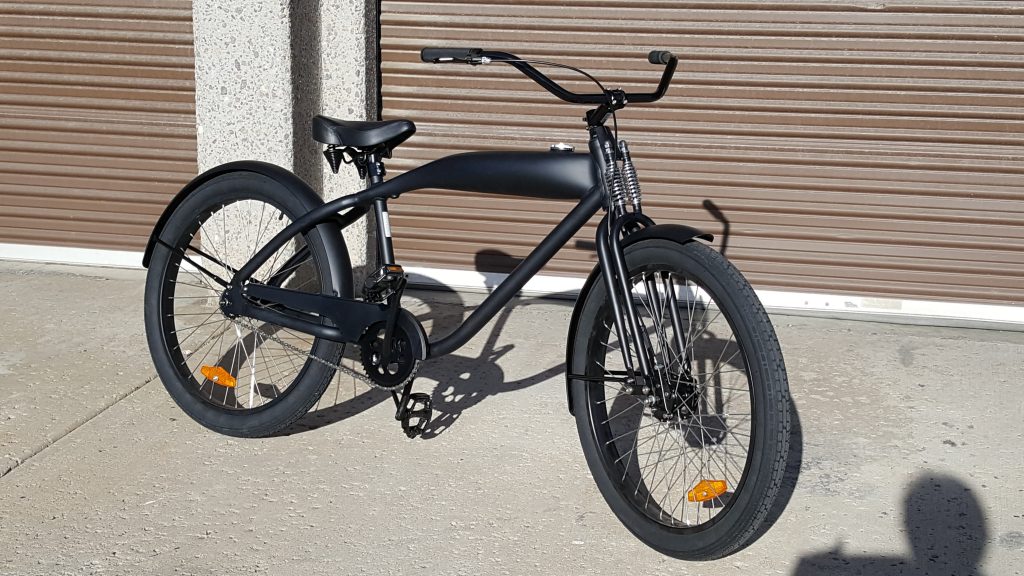 A black bicycle parked in front of a garage.