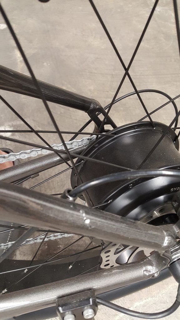 A close up of a bicycle wheel with a chain.