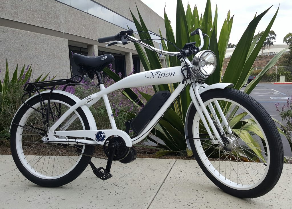 A white electric bike parked in front of a building.