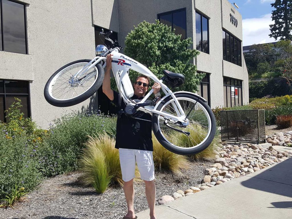 Phantom Bikes owner, John King, lifting the Phantom R bicycle