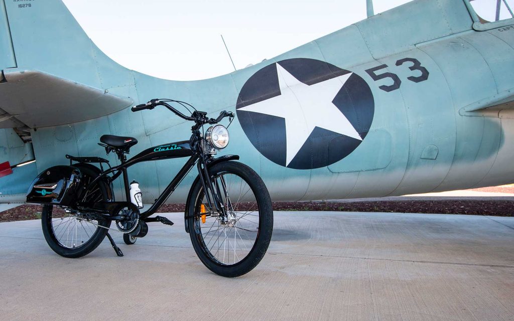 A black Santa Fe Classic electric bike next to a jet