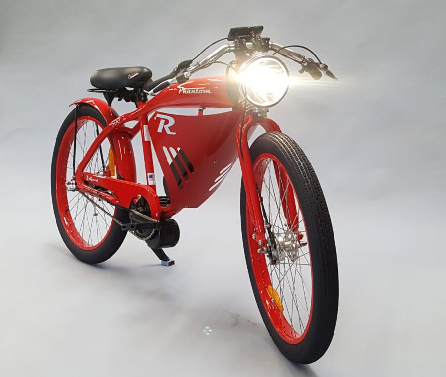 A red electric bike with a headlight on it.